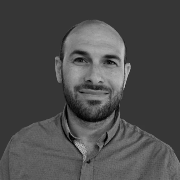 Ari Toren-Herrinton, technology consultant, smiling outdoors in the Pacific Northwest